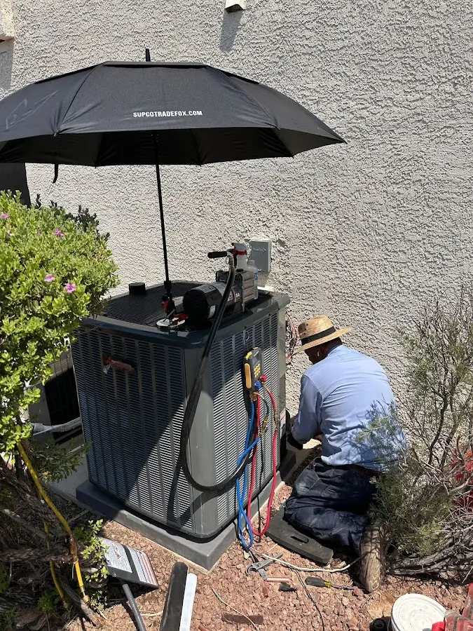 HVAC technician performing outdoor AC maintenance in Daytona Beach Shores